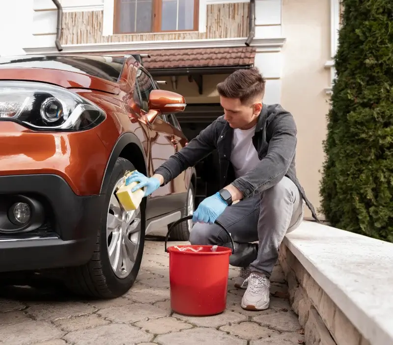 Lavage auto à domicile Vallon-en-Sully : professionnel intervenant sur un véhicule